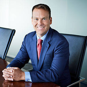 James W. Hutchison smiling in a conference room seated.