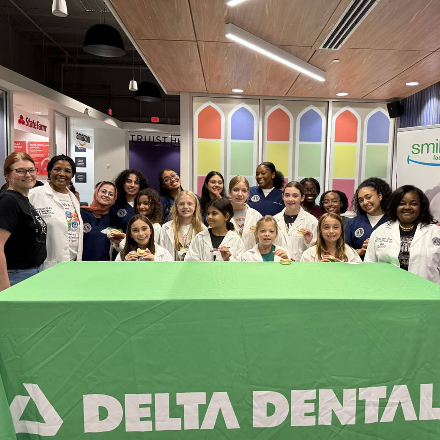 Group of children from the Delta Dental team at the clinic, participating in fun dental education activities.